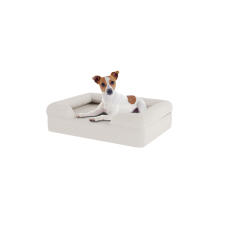 Hund sitzt auf kleinen meringue weißem memory foam nackenrolle hundebett